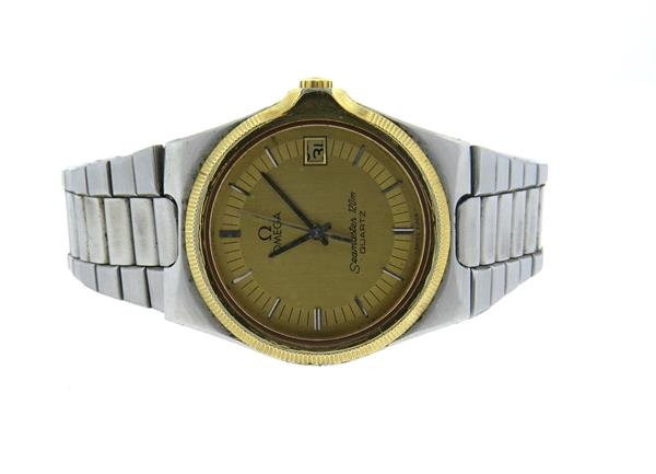 Omega Seamaster Two Tone Quartz Watch: Two tone stainless steel case - 35mm in diameter . Quartz movement - not running. Gold tone dial with silvered stick markers, center second hand, date at 3 o'clock. Missing a pusher. Omega band. G