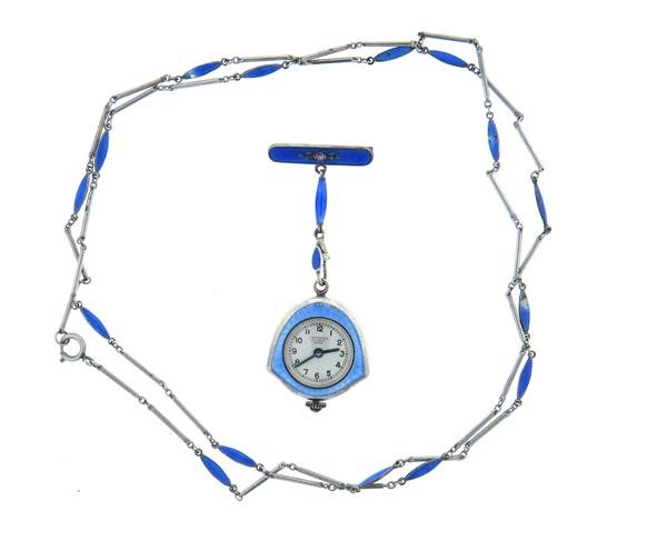 Art Deco Bucherer Lucerne Guilloche Enamel Lapel Watch: Silver guilloche enamel case - 24mm x 24mm. Back crafted with marcasite stones. Manual wind - running order. Measurements with the brooch - 65mm (incl. crown and pin). Silver chain - 30" long. Ge