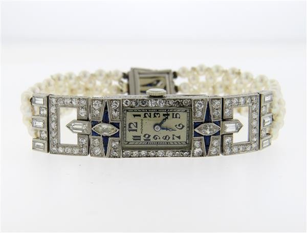 Art Deco Movado Platinum Diamond Pearl Lady's Watch: Platinum case - 14mm excl crown x 61mm lug tip to lug tip. Decorated with diamonds and sapphires - Diamonds approx. 4.50ctw. Pearl bracelet - 7" long, clasp also set with diamonds and sapphires. 