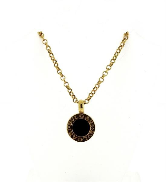 Bulgari Bvlgari 18K Gold Onyx Station Pendant Necklace: Bvlgari pendant features onyx center. Measures 19mm long (including bale) x 13.2mm wide. Necklace measures 14.5" long. Marked Bvlgari, AU750, Made in Italy. Weight - 9.1 grams. Retail for $1470.G