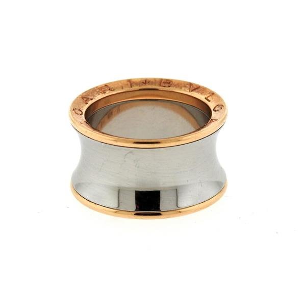 Bvlgari Bulgari 18k Gold Steel Wide Band Ring: METAL: stainless steel/ 18k gold. MEASUREMENTS: ring size 7, ring is 12.5mm wide. MARKED: Bvlgari, PM30269, steel, 750, 57, Italian marks. WEIGHT: 10.7 grams.Gemstones have not been graded for color a