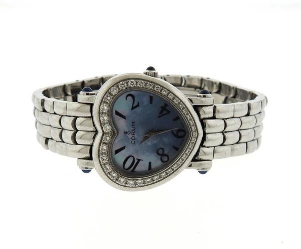 Corum Steel Diamond Mother of Pearl Heart Watch: METAL; stainless steel. MEASUREMENTS: heart shape case - 30mm x 27mm. Band will fit up to 6 1/2" wrist. GEMSTONES: sapphires on crown and lugs, diamonds on bezel, mother of pearl dial. MOVEMENT: