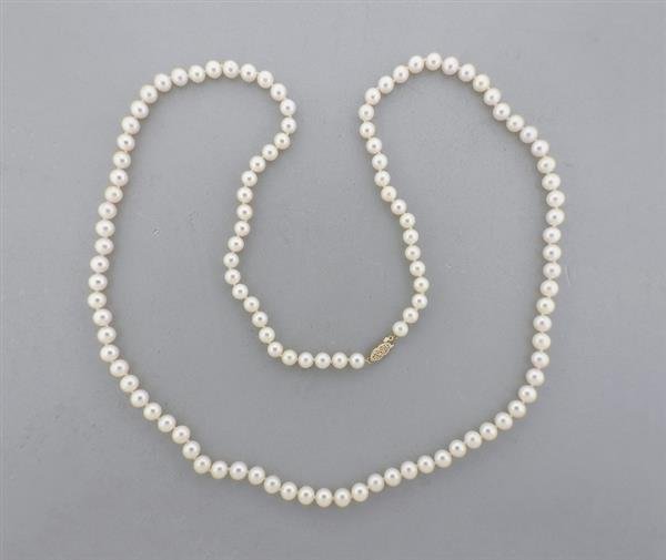 14K Gold 7-7.5mm Pearl Necklace: METAL: 14K Gold. GEMSTONES: Pearls range from 7-7.5mm in diameter. MEASUREMENTS: Necklace is 36" long. MARKED: 14K. WEIGHT: 63.4 grams. Gemstones have not been graded for color and clarity ,and t