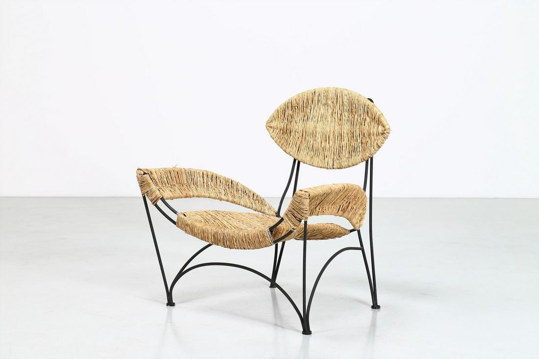 TOM DIXON Armchair.: Armchair. Painted metal and straw. Cm 93,00 x 90,00 x 73,00. Modello Banana, Produzione Cappellini, Italia, anni 80.