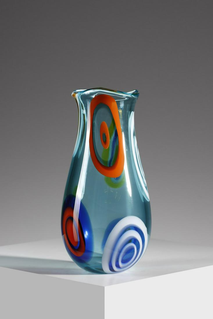 GIANMARIA POTENZA Vase in blue glass decorated with murrine with concentric orange and lattimo rings: Vase in blue glass decorated with murrine with concentric orange and lattimo rings for La Murrina. Murano glass.. Cm 13,00 x 28,00. Signature under the base, 1960s.