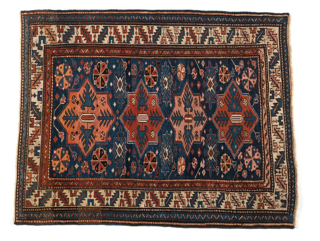 DAGHESTAN A carpet with medallion decoration on a blue field, Caucasus, late 19th century. (1 of 2)