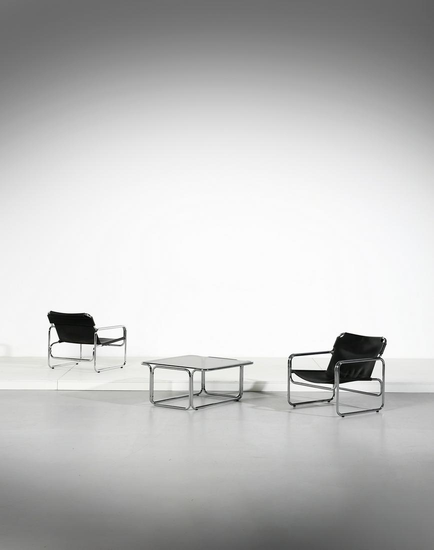MANIFATTURA ITALIANA Pair of armchairs and coffee table.: ITALIAN WORK Pair of armchairs and coffee table. Chromed metal, leather and glass. Cm 65,00 x 65,00 x 61,00. 1970sCoffee table: 38 x 80 x 80 cm