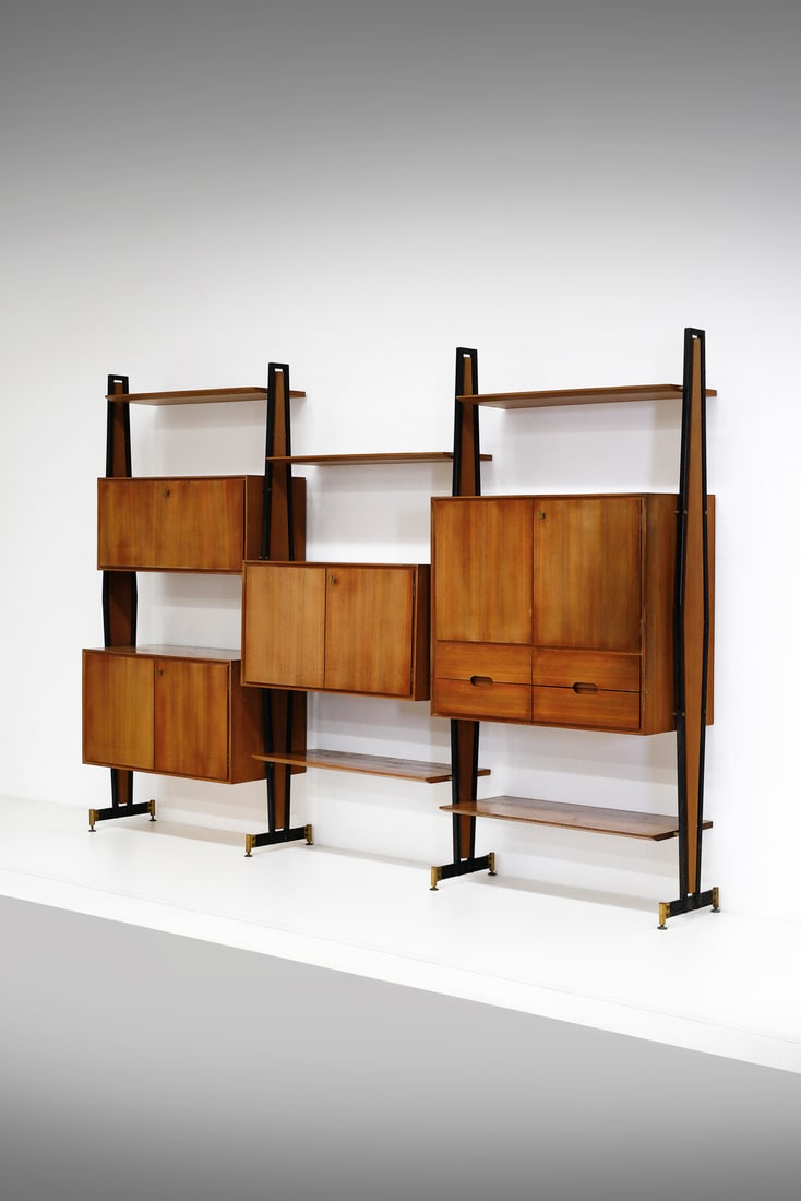 LA PERMANENTE MOBILI CANTUâ€™ Three bay bookcase with open shelves, cabinets and drawers.: Three bay bookcase with open shelves, cabinets and drawers. Teak wood, iron, brass and glass.. Cm 285,00 x 200,00 x 45,00. 1950s.Label and mark "CONSORZIO ESPOSIZIONE MOBILI CANTU'".