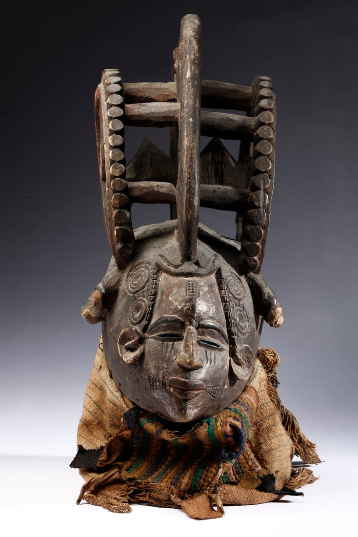 Igbo - Nigeria  Anthropomorphic mask with elaborate hairstyle. Dark patina wood, pigments, and (1 of 4)