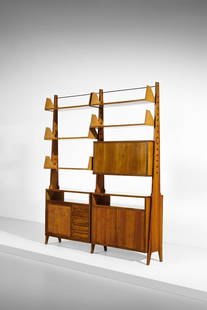 PIERLUIGI SPADOLINI Modular bookcase with cabinets, drawers and open shelves adjustable in height.: SPADOLINI PIERLUIGI (1922 - 2000) Modular bookcase with cabinets, drawers and open shelves adjustable in height. 1954. Walnut, brass and hardboard.. Cm 198,50 x 232,00 x 37,00. Presented at the X