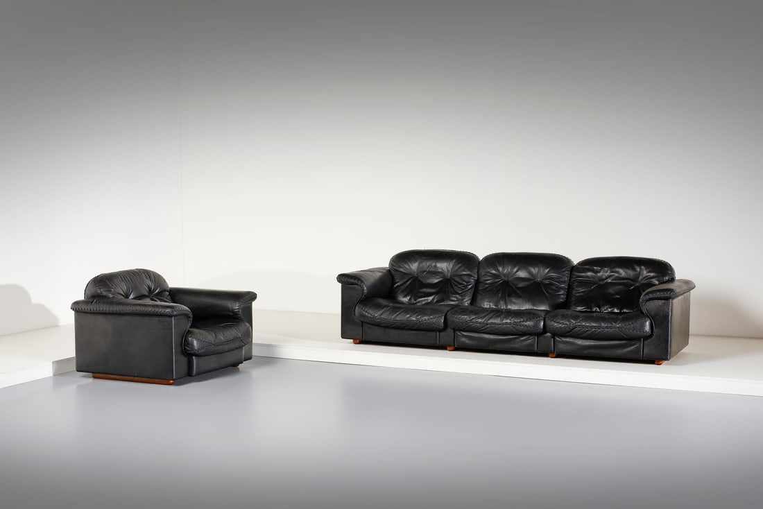 DE SEDE Three-seater sofa and an armchair.: DE SEDE Three-seater sofa and an armchair. Wood and leather.. . 1970s.Dimensions: sofa 70 x 260 x 95 cm; armchair 70 x 108 x 106 cm