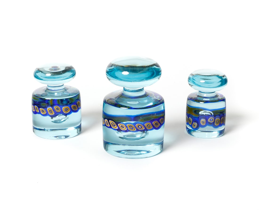 GIANMARIA POTENZA S/207 three weights for La Murrina, Murano.: POTENZA GIANMARIA (n. 1936) S/207 three weights for La Murrina, Murano. Light blue glass decorated with band of blue, yellow and lattimo murrine.. . 1960s.Dimensions: 14 x 8,5 x 8,5 cm; 11 x 7,5 x 7,5