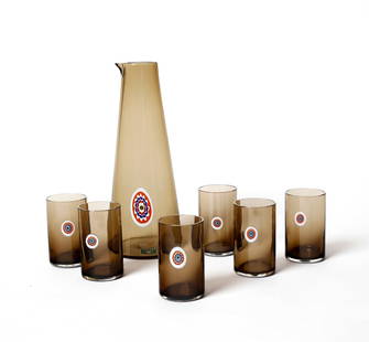 PETER PELZEL Carafe and six glasses for Vistosi, Murano.: PELZEL PETER (n. 1937) Carafe and six glasses for Vistosi, Murano. Transparent smoked glass decorated by a polychrome murrine.. . 1960s.Manufacturer's label.Dimensions: 32 x 13 x 13 cm; 11 x 6 x 6 cm
