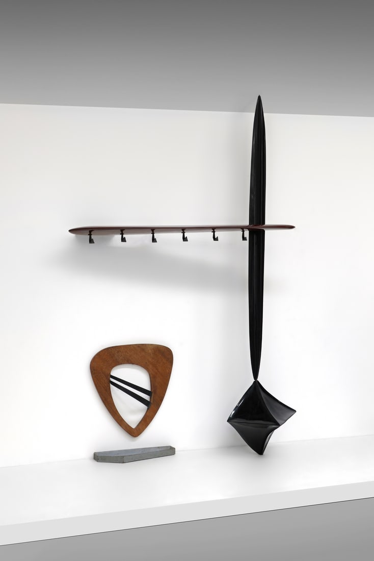 PIERLUIGI GIORDANI Coat hanger with umbrella stand.: GIORDANI PIERLUIGI Coat hanger with umbrella stand. Natural walnut wood, ebonized walnut wood and lacquered brass.. Cm 200,00 x 280,00 x 60,00. Umbrella stand: 80 x 65 x 15 cm.It is a sculpture to whi