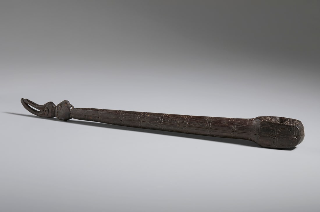 WOODEN HANDLE OF AN ASMAT CEREMONIAL AXE.Papua New Guinea, Early 20th century.. (1 of 6)