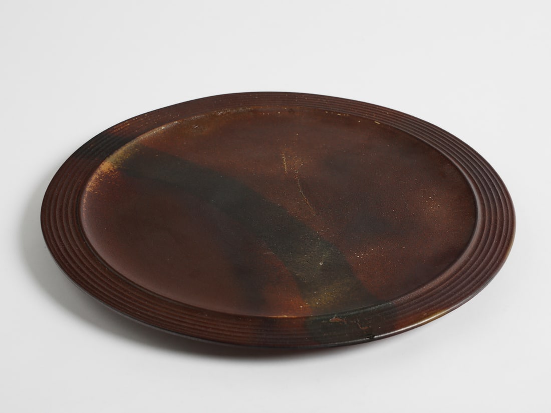 MANIFATTURA CERAMICA ARCORE Large centerpiece.: MANIFATTURA CERAMICA ARCORE Large centerpiece. Brown glazed stoneware.. Cm 49,50 x 49,50 x 2,50. 1970s.Signed "CA" under the base.