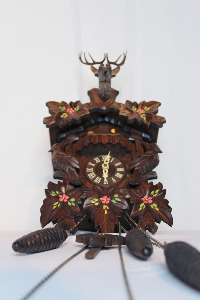 Black Forest German Cuckoo Clock: Frohlicker Wanderer Holzhackern German Black Forest Cuckoo ClockLarge Carved Black Forest Cuckoo Wall Clock. Eight day, weight driven wall clock has a carved face surround two birds and three oak leav