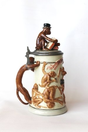 Ca. 1900 Pottery Stein Monkeys w/ Figural Monkey Inlay: Around the year 1900, stamped: Germany, protected by law, model number. 1402, RS. Calibration mark 0.5 L, cream-colored stoneware, modeled monkeys colored glazed, with banner: in the struggle for exis