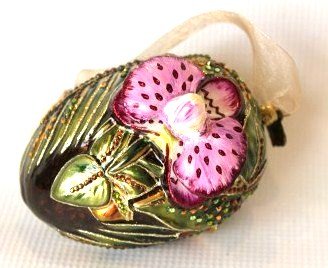 Jay Strongwater Crystal Ornament- Oval with 3D Orchid: Jay Strongwater Oval 3D Orchid and Bold Leaves. Colors include: green, fuschia, pink, orange and gold. Measures approximately 4.5 x 4.