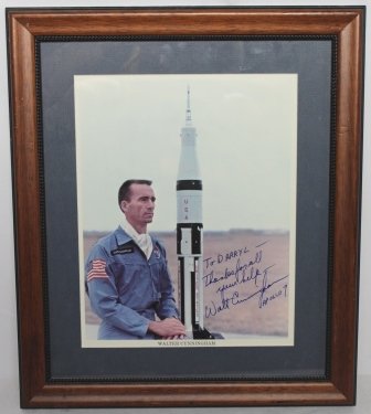 Apollo 7 Walter Cunningham Signed Photo: WALTER CUNNINGHAM Official NASA S.P., 8" x 10" color showing Cunningham in a NASA jumpsuit as he regards a Saturn V model before him, signed: "Walt Cunningham Apollo 7"