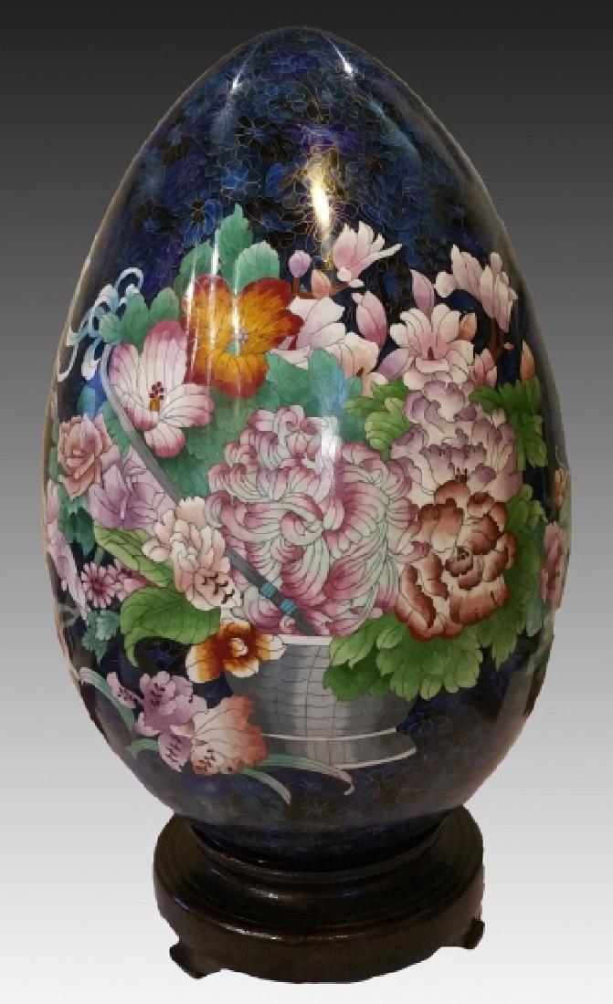 JAPANESE CLOISONNE EGG: Large antique Japanese Cloisonne egg with designs of flowers on blue ground. With wooden base, 53" x 33"
