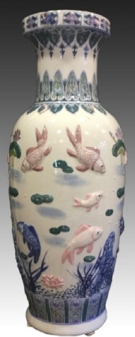 CHINESE FISH VASE: Large vintage Chinese porcelain floor vase with raised design of fishes and lotus leaves. 31"