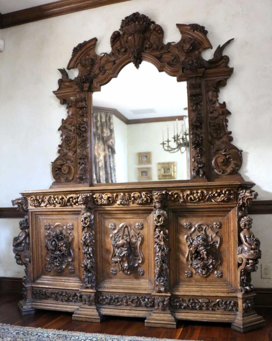 SWISS BLACK FOREST CARVED MONUMENTAL HUNTBOARD: IMPORTANT SWISS ANTIQUE BLACK FOREST OAK HAND CARVED MONUMENTAL HUNTBOARD WITH MIRRORED BACK SPLASH. WELL CARVED GRIFFON, PUTTI, FLORAL GAME & FOWL CARVINGS. ORIGINAL PURCHASE PRICE $20,000.00 108 X 8
