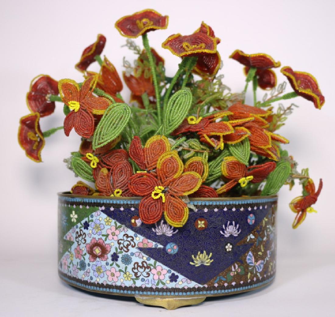 JAPANESE MEIJI PERIOD CLOISONNE JARDIENIERE: Geometrically decorated fine CloisonnÃ© jardiniÃ¨res on three brass feet. Over three inches tall and 8 inches across.