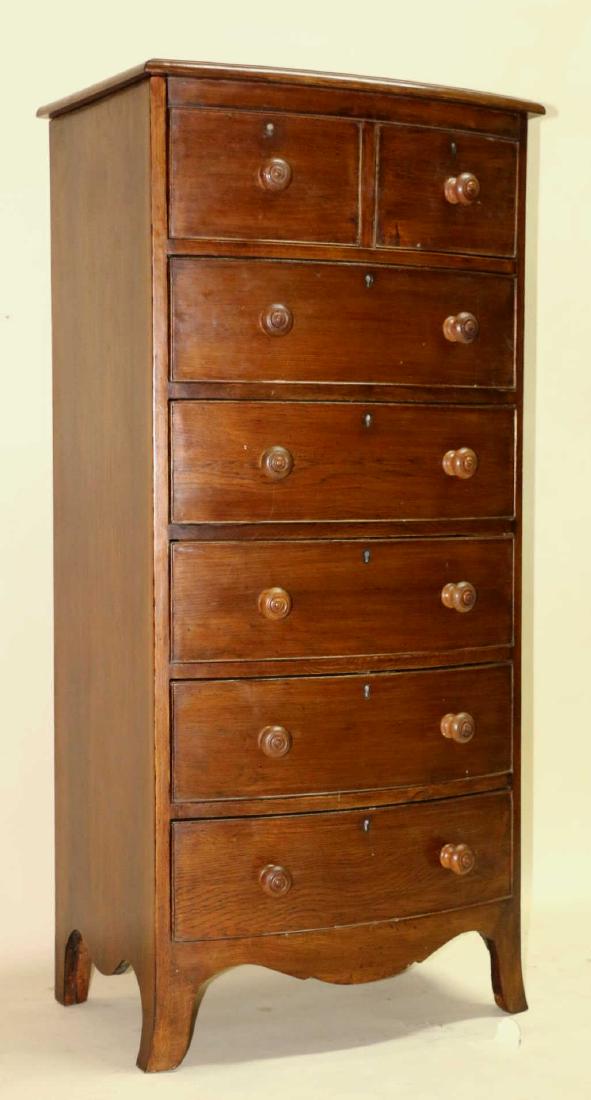 ENGLISH ANTIQUE BOW FRONT MAHOGANY TALL CHEST: ENGLISH ANTIQUE BOW FRONT MAHOGANY TALL CHEST. THE TALL LINGERIE STYLE CHEST RESTS ON SPLAYED BRACKET FEET WITH ORIGINAL PULLS