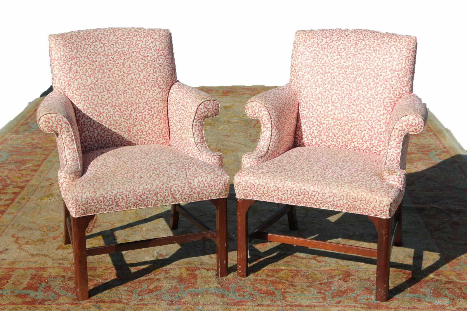 ENGLISH MAHOGANY WINGBACKS WITH CORAL UPHOLSTERY: PAIR OF ENGLISH MAHOGANY WINGBACKS FROM PALM BEACH ESTATE WITH CUSTOM CORAL UPHOLSTERY