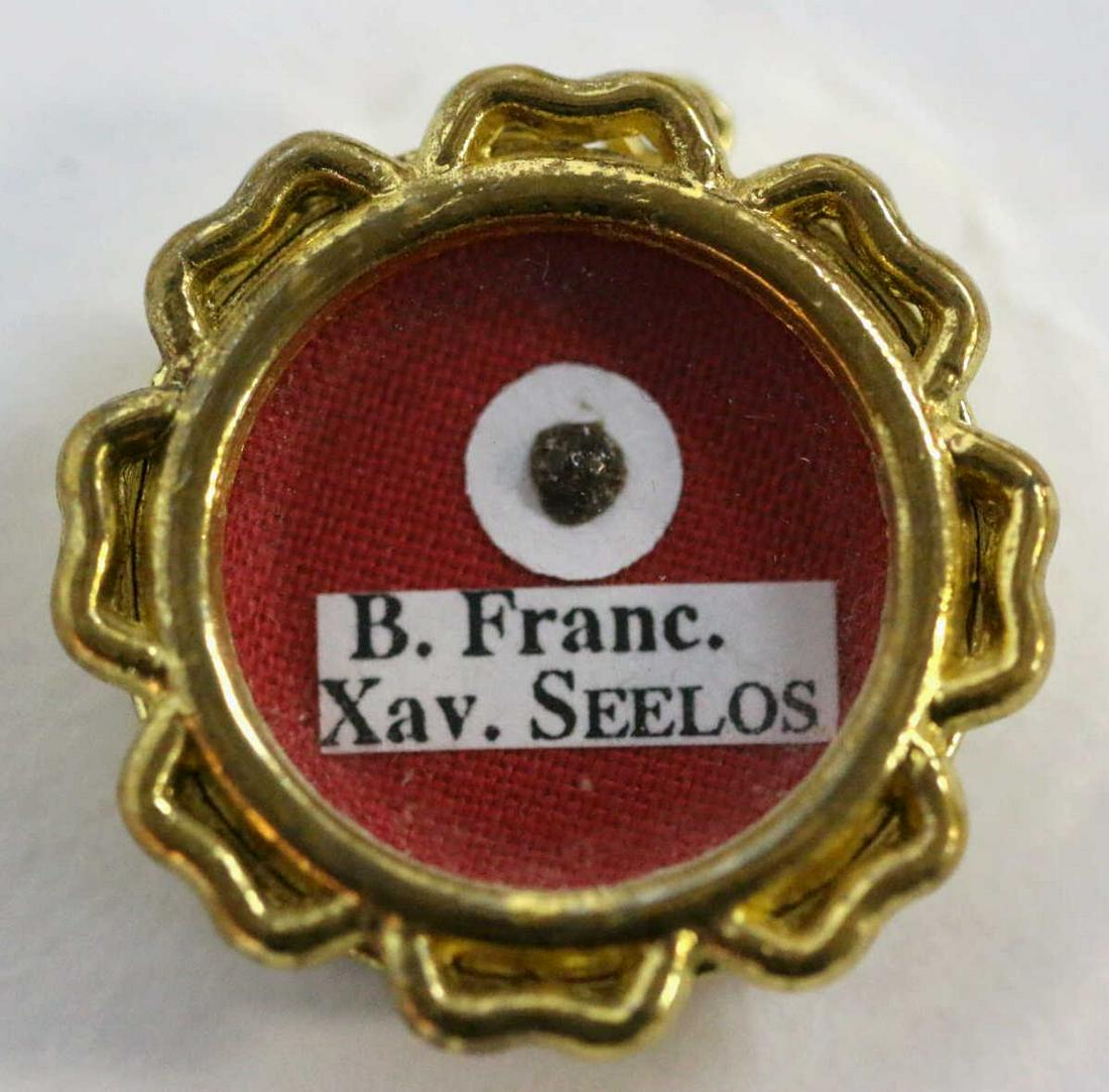 SAINT FRANCIS XAVIER SEELOS FREGMENT RELIC LOCKET: SAINT FRANCIS XAVIER SEELOS FREGMENT RELIC MOUNTED IN ANTIQUE LOCKET (PROBABLY A STERNUM BONE FRAGMENT OF THE SAINT) CIRCA 1819