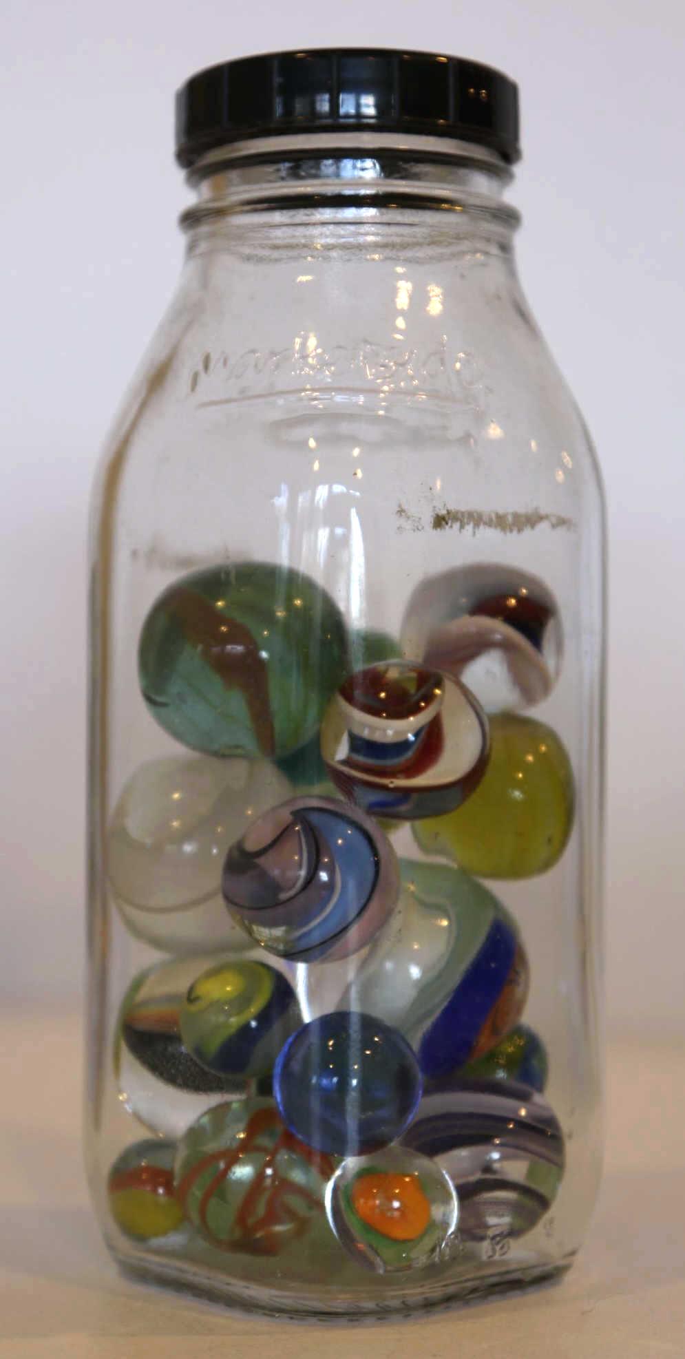MARBLE GROUPING IN JAR: FROM THE SPARTA ESTATE A MARBLE GROUPING IN JAR WITH MANY MARBLES HAVING SWIRLS AND VARIOUS SIZES OF MARBLES