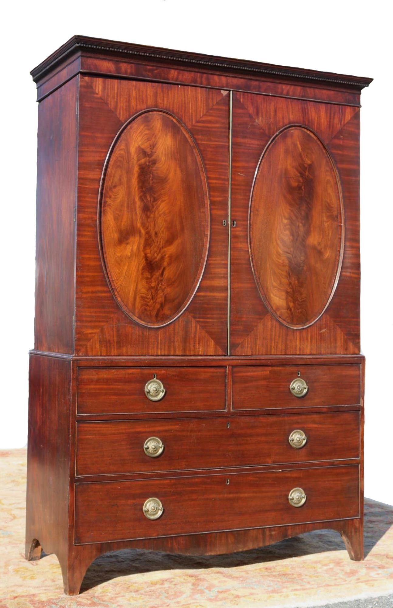 ENGLISH ANTIQUE MAHOGANY VERY FINE LINEN PRESS: ENGLISH ANTIQUE MAHOGANY LINEN PRESS WITH OVAL INSET BANDED CROTCH MAHOGANY PANELS RESTING ON ORIGINAL DISPLAYED BRACKET FEET