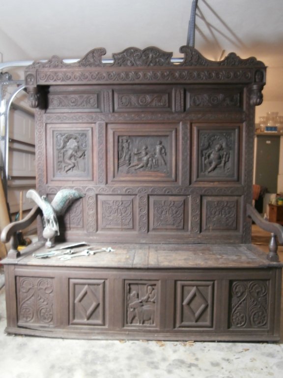 LARGE CARVED OAK SETTEE:: Large carved oak settee. Over 6' tall and 7' wide.