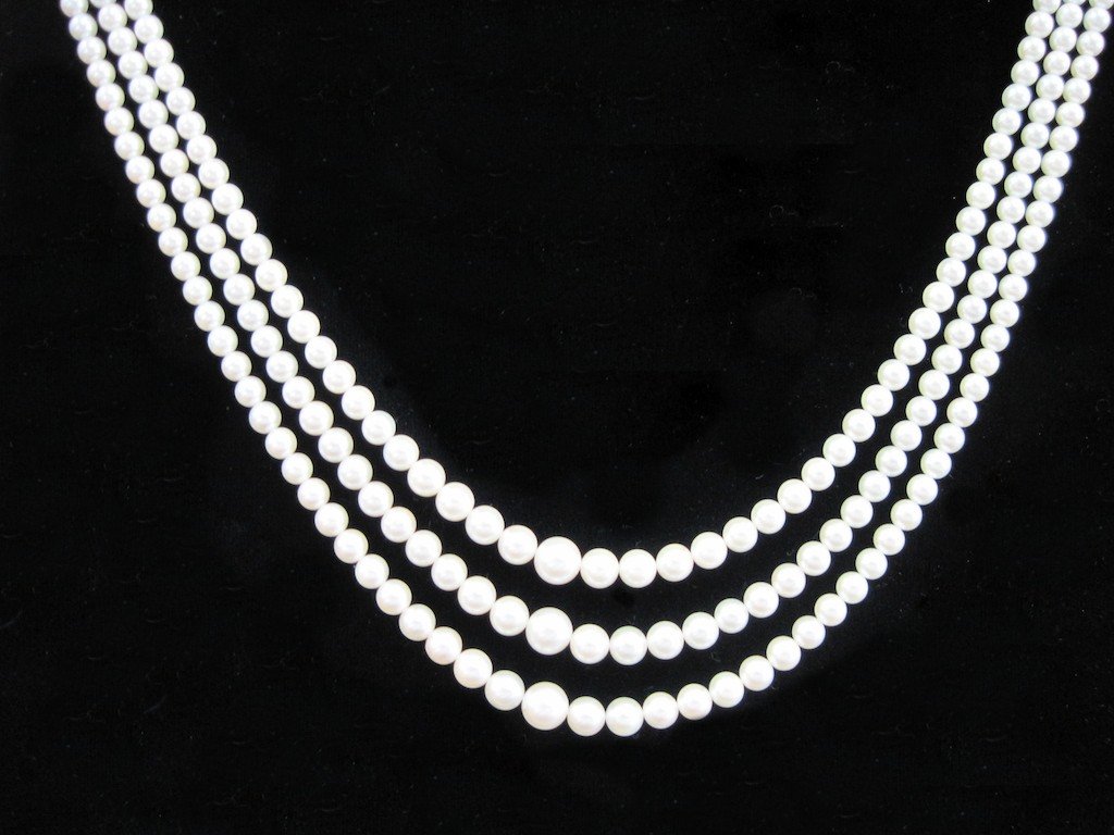 LADIES HAND KNOTTED TRIPLE STRAND MIKIMOTO PEARLS:: Very fine vintage Mikimoto hand knotted triple strand pearls. 14KYG clasp. Exceptional luster and color.