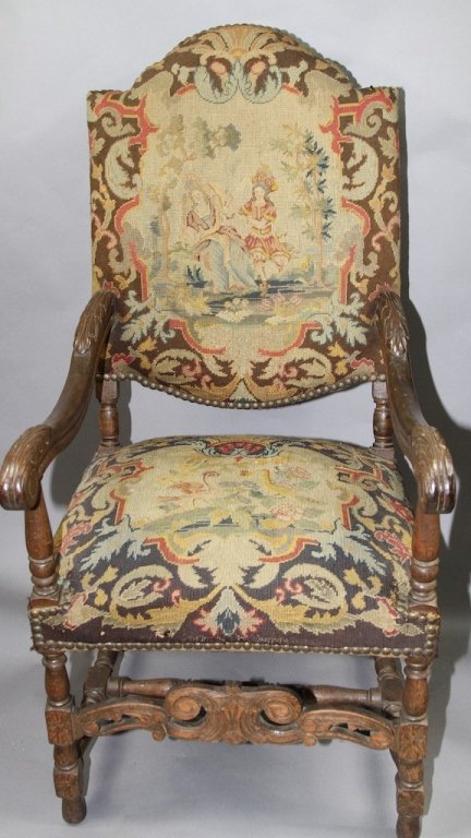 CARVED ANTIQUE NEEDLEPOINT ARMCHAIR: 48"H X 23"W X 21"D.