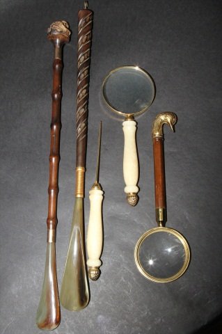 LOT OF VINTAGE SHOE HORNS & MAGNIFIERS:: Two shoe horns, two magnifying glasses and a letter opener. Shoe horn with man:1' 10"H. Shoe horn: 1'9"H Duck magnifying glass: 10.5"H X 3.5" in diameter. Magnifying glass: 9.5"H X 3.5" in diameter. L