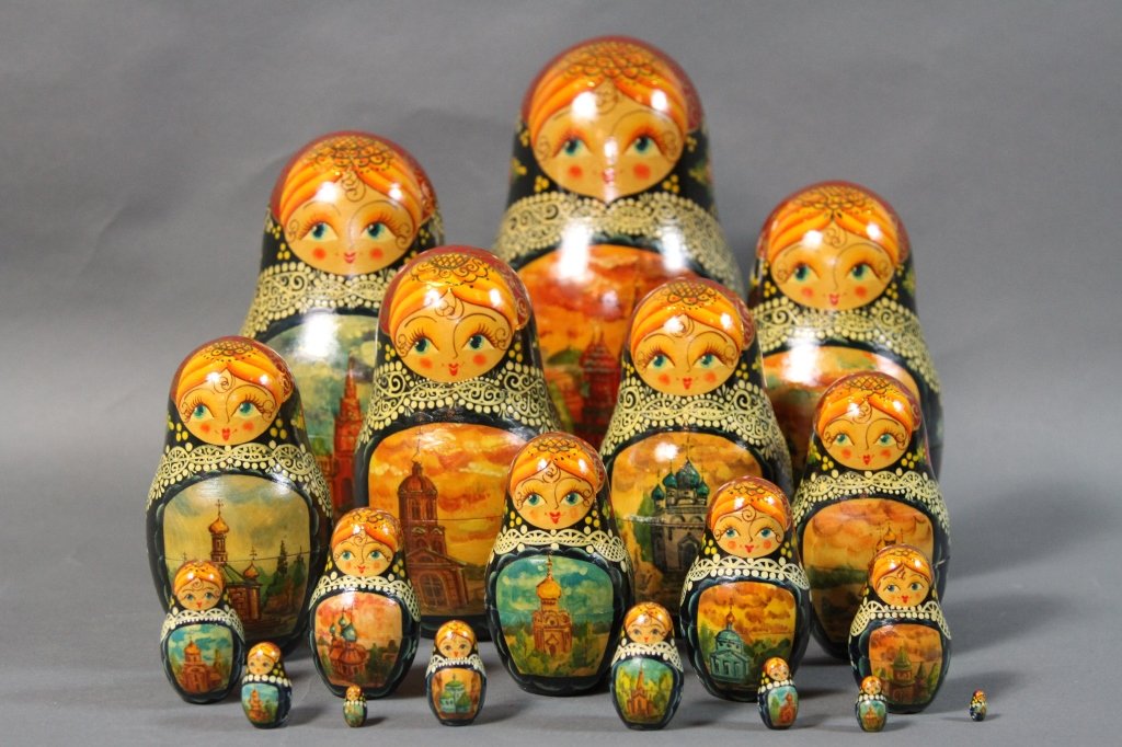 RUSSIAN NESTING DOLLS:: 20 hand crafted and hand painted Russian Nesting dolls. 1993 signed. 12"H