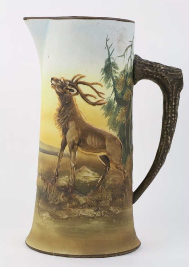 NIPPON BLUE BLOWN OUT ELK TANKARD: Nippon Blue Blown Out Elk Tankard: Hard-to-find blown out tankard featuring a male elk standing at the edge of the woods raising his head as if to call a mate. The background is blue. The handle is si