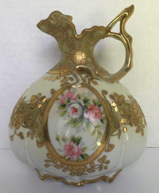 NIPPON EWER WITH ROSES AND GOLD OVERLAY: Nippon Ewer with Roses and Gold Overlay: Vase features roses with gold overlay. Blue M Wreath; approximately 8" high; Good condition.