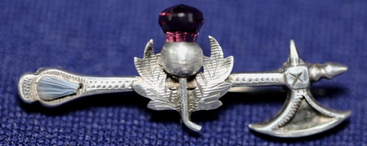 STERLING SILVER THISTLE PIN WITH AXE AND AMETHYST: STERLING SILVER THISTLE PIN WITH AXE AND AMETHYST
