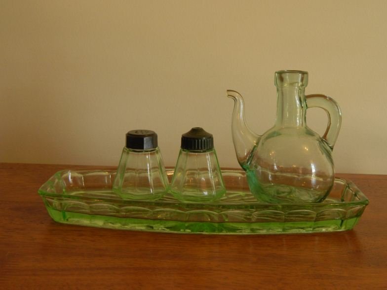 Four-piece green glass cruet set: Four-piece green glass cruet set; salt & pepper are Uranium glass