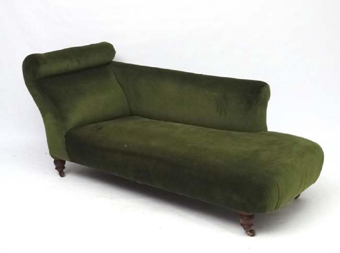 An early 20thC upholstered chaise longue. 29'' high x: An early 20thC upholstered chaise longue. 29'' high x 64'' long