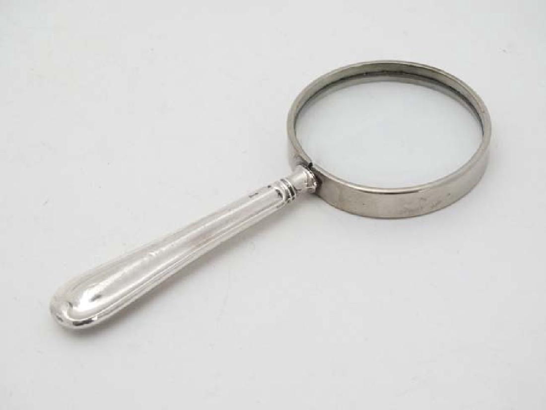 A silver handled magnifying glass. 5'' long (1 of 3)