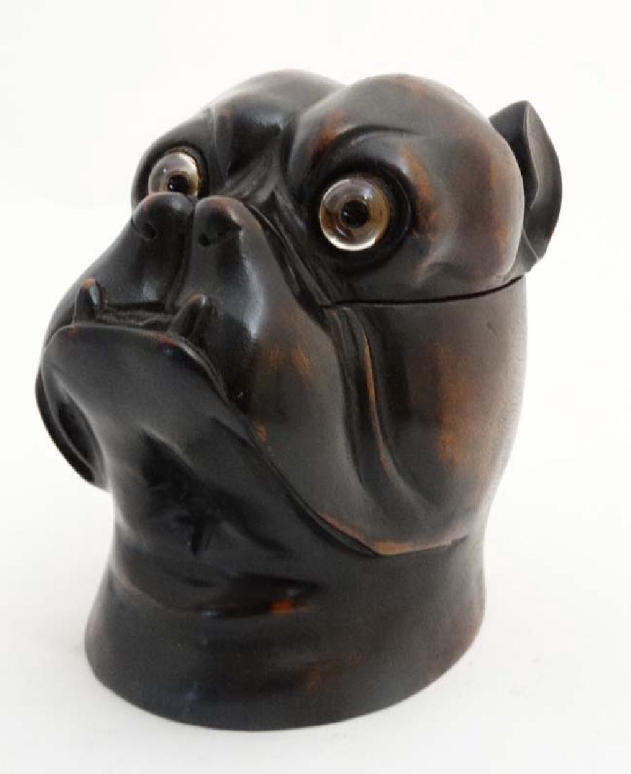 Black Forest : a 20 thC tobacco jar in the form of a: Black Forest : a 20 thC tobacco jar in the form of a Boxer Dog head having glass eyes.5 3/4'' high