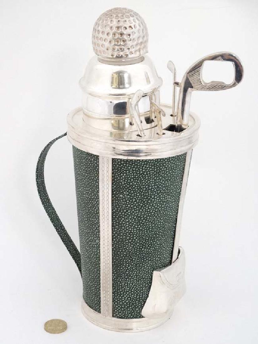 A late 20thC Novelty cocktail set formed as a gold bag: A late 20thC Novelty cocktail set formed as a gold bag containing four swizzle sticks formed as various golf clubs, a bottle opener / corkscrew formed as a golf club and central individual cocktail sh