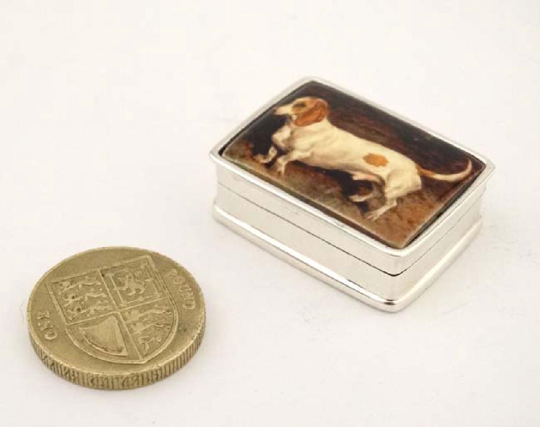 A .925 silver pill box with hinged lid depicting enamel: A .925 silver pill box with hinged lid depicting enamel image to top depicting a dachshund dog. 21stC 1 1/4'' wide
