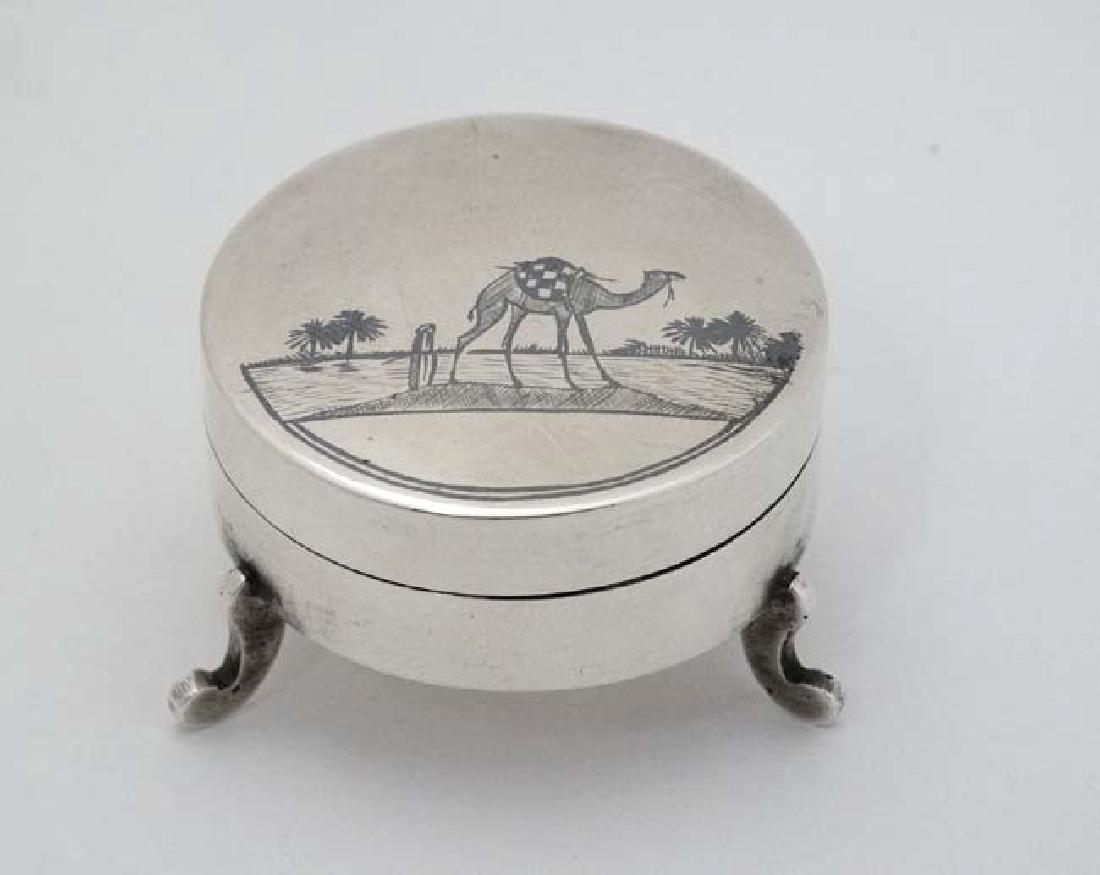 A white metal pot and cover on three shaped feet and (1 of 5)
