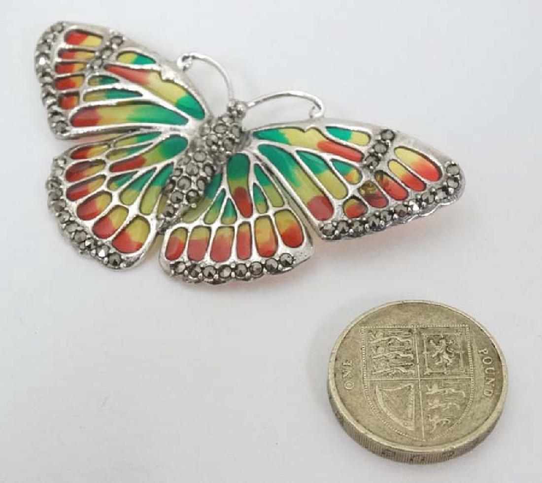 A silver brooch formed as a butterfly with enamel and (1 of 5)