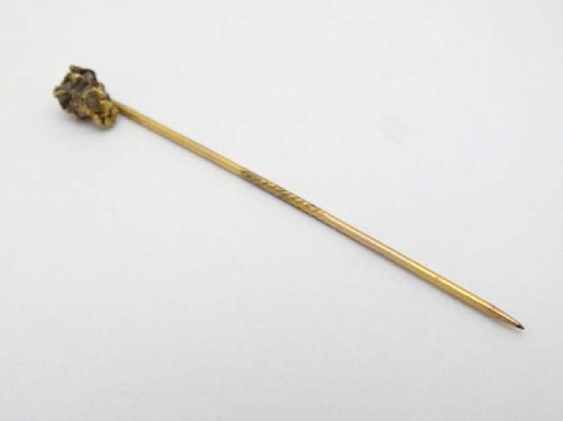 A gilt metal stick pin surmounted by gold nugget style (1 of 4)